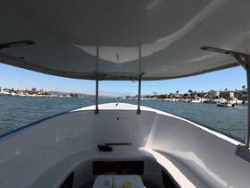 View from the helm of a boat, showcasing the interior space and the waterway ahead, perfect for navigating through scenic coastal areas.