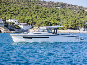 A sleek Nimbus Velos yacht cruising through clear waters, showcasing its elegant design and performance against a scenic coastal backdrop.