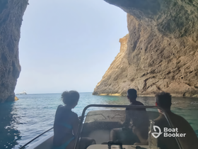 A group of friends enjoys a scenic boat ride through a cave, capturing the essence of adventure and exploration on the water.