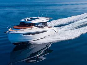 A stunning aerial view of a sleek yacht cruising through calm blue waters, showcasing its elegant design and smooth performance.