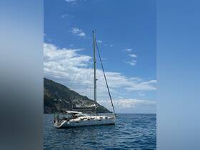 A beautiful sailboat anchored in serene waters, surrounded by stunning coastal scenery — perfect for sailing adventures along the coast.