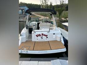 A clear view of the back of the 'Big Red' boat docked at the Port of Osage Beach, showcasing its spacious deck and sleek design, perfect for summer outings.