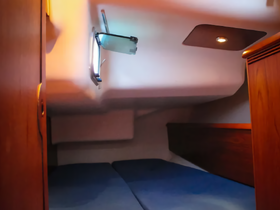 Interior view of a cozy cabin space on a boat, featuring comfortable seating and warm lighting, perfect for relaxation during voyages.