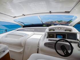 The sleek helm of a Pershing yacht, showcasing modern controls and a panoramic view of the ocean, perfect for navigating luxurious adventures on the water.