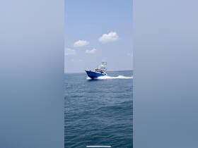 A striking speedboat cuts through the clear blue waters, showcasing its sleek design and powerful performance on a sunny day.