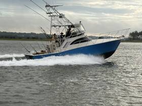 A fishing boat speeds through the water, showcasing an exciting day on the water with anglers ready for adventure.