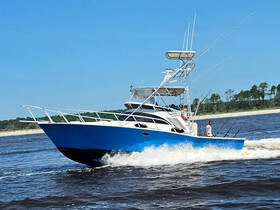 A sleek fishing boat speeds through the water, with anglers ready for a catch — perfect for an exciting day on the water.