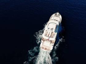 A stunning aerial view of a yacht cruising through deep blue waters, showcasing its elegant design and smooth motion.