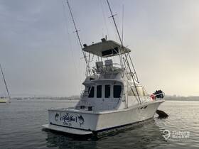 A striking view of a fishing yacht docked in calm waters, showcasing its sleek design and fishing capabilities — perfect for sport fishing enthusiasts.