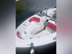A close-up view of the interior seating and helm of a sleek boat, showcasing its modern design and comfort features, perfect for a day on the water.