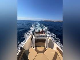 A sleek speedboat cruising through clear blue waters, showcasing its stylish design and comfortable seating. Perfect for thrilling adventures on the open sea.