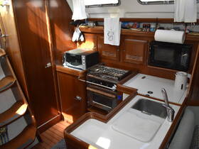 A well-equipped boat kitchen featuring a microwave, stove, and sink, showcasing the cozy interior space ideal for meal preparation while on the water.