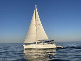 A beautiful sailboat glides through calm waters under a clear blue sky, showcasing the perfect setting for a day of sailing adventures.