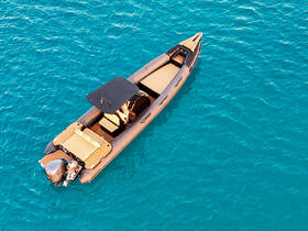 A stunning aerial view of a sleek speedboat gliding through crystal-clear turquoise waters, perfect for thrilling adventures on the open sea.
