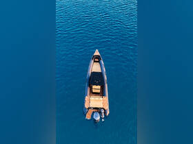 Aerial view of a sleek speedboat floating on crystal-clear waters, showcasing its elegant design and spacious seating — perfect for thrilling adventures on the open sea.