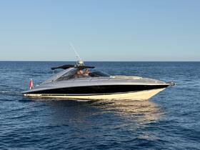A sleek Sunseeker yacht glides through the water with guests onboard, showcasing the perfect blend of luxury and adventure on the open sea.