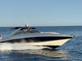 A sleek speedboat cuts through the water with a smiling captain at the helm, showcasing the thrill of boating adventures on the open sea.