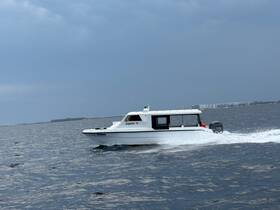 A sleek speedboat named 'Jupiter 11' glides through the water, showcasing its dynamic design and performance on the open sea.