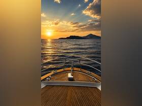 A stunning sunset view from the bow of a boat, showcasing the tranquil waters and distant islands — perfect for serene evening cruises.