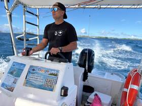 A captain skillfully navigates a boat through the open ocean, showcasing the thrill of boating adventures on the water.