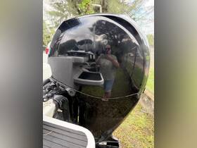 A close-up shot of a boat motor with a reflection of a person, but the focus is unclear and the main subject is ambiguous.