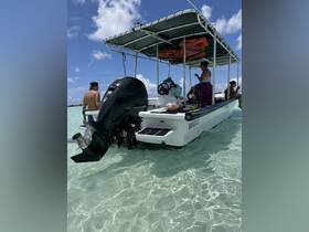 A lively scene on a boat with guests enjoying their time in clear waters, showcasing the perfect atmosphere for a fun day out on the water.