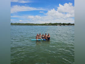 A cheerful group enjoys a refreshing swim in the water, showcasing the fun and camaraderie of a perfect day on the water.
