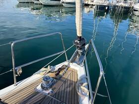A close-up view of the bow of a yacht docked in calm waters, showcasing its sleek design and polished features.