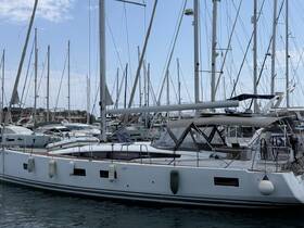 A sleek yacht docked at a marina, surrounded by other vessels, showcasing the beauty of nautical design and craftsmanship.