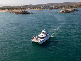 A group enjoys a scenic boat ride along the coastline, showcasing the beauty of the surrounding landscape and the excitement of being on the water.