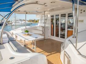 A beautifully designed interior of a boat featuring a spacious seating area and helm, perfect for relaxing or navigating the waters.