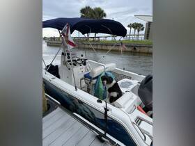 A cozy view of the interior of a boat featuring a helm and seating area, perfect for a day on the water. A dog relaxes on the seat, adding a touch of companionship to the boating experience.
