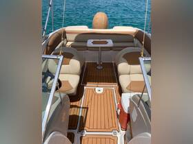 Interior view of a spacious boat cabin featuring comfortable seating and a central table, perfect for relaxing on the water.