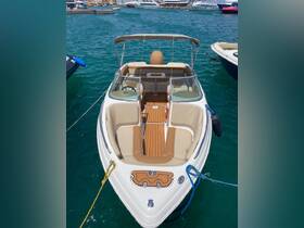 A well-appointed interior view of a boat showcasing comfortable seating and a helm, perfect for leisurely outings on the water.