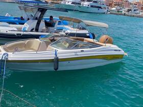 A sleek speedboat named Moka 2700 docked in clear turquoise waters, showcasing its stylish design and comfortable seating.