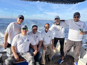 A group of friends enjoys a day out on the water, showcasing camaraderie and fun aboard their fishing boat — perfect for creating lasting memories.