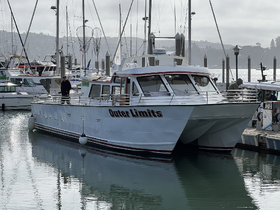 The 'Outer Limits' yacht is docked in a marina, showcasing its sleek design and inviting atmosphere, perfect for fishing trips or leisurely cruises.