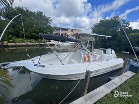 A sleek speedboat docked by the shore, showcasing its elegant design and ready for a day on the water.