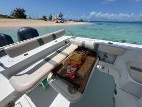 A selection of snacks including chips and bread laid out on a boat, perfect for enjoying a day on the water with friends or family.