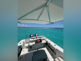 Interior view of a boat showcasing comfortable seating and helm area, perfect for relaxing while enjoying the stunning turquoise waters.