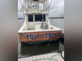 The rear view of the 'Nauti Girl' boat docked at Freeport, showcasing its distinctive name and design, perfect for fishing or leisure trips.