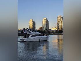 A stylish yacht glides through the water with guests enjoying the scenic city backdrop — perfect for urban boating adventures.