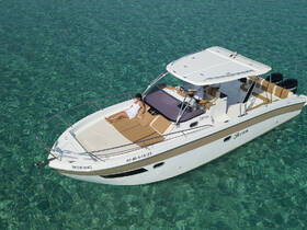 A person relaxes on the deck of a sleek boat, enjoying the sun above crystal-clear waters — an ideal setting for a day of leisure on the water.