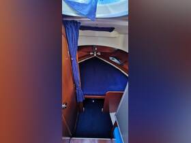 Interior view of a cozy boat cabin featuring a comfortable sleeping area, perfect for relaxing during a sailing trip.