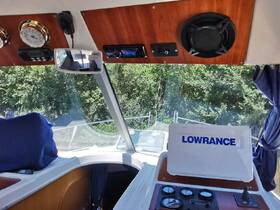 An interior view of a boat's helm showcasing the control panel and instruments, ideal for navigation and steering.