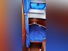 Interior view of a cozy boat cabin featuring plush seating and wooden accents, ideal for relaxation during voyages.