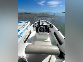 Interior view of a boat's helm and seating area, showcasing the console and comfortable seating, perfect for a day on the water.