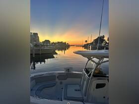 A serene sunset view from the deck of a boat, showcasing the tranquil harbor and surrounding buildings — perfect for evening cruises or peaceful reflections on the water.
