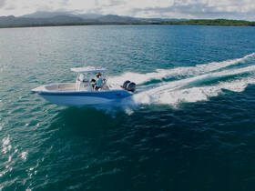 A speedboat glides through turquoise waters, showcasing an exhilarating day on the water. Perfect for adventure seekers looking to explore coastal destinations.