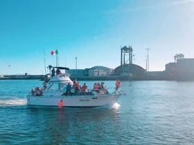 A lively group enjoys a boat ride, showcasing the excitement of on-water activities with safety gear in a vibrant setting.